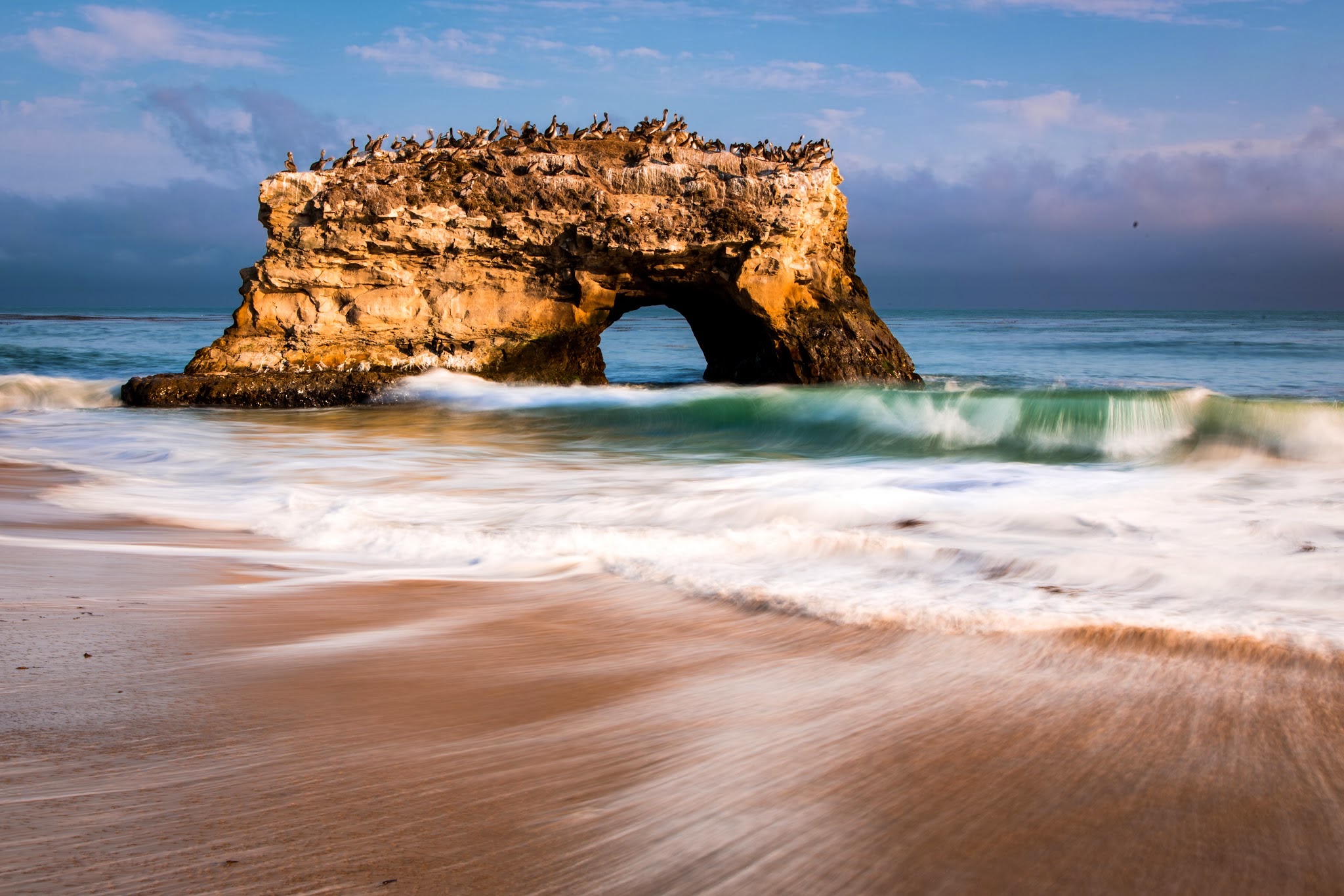 Download mobile wallpaper Sea, Beach, Rock, Horizon, Bird, Ocean, Earth, Arch for free.