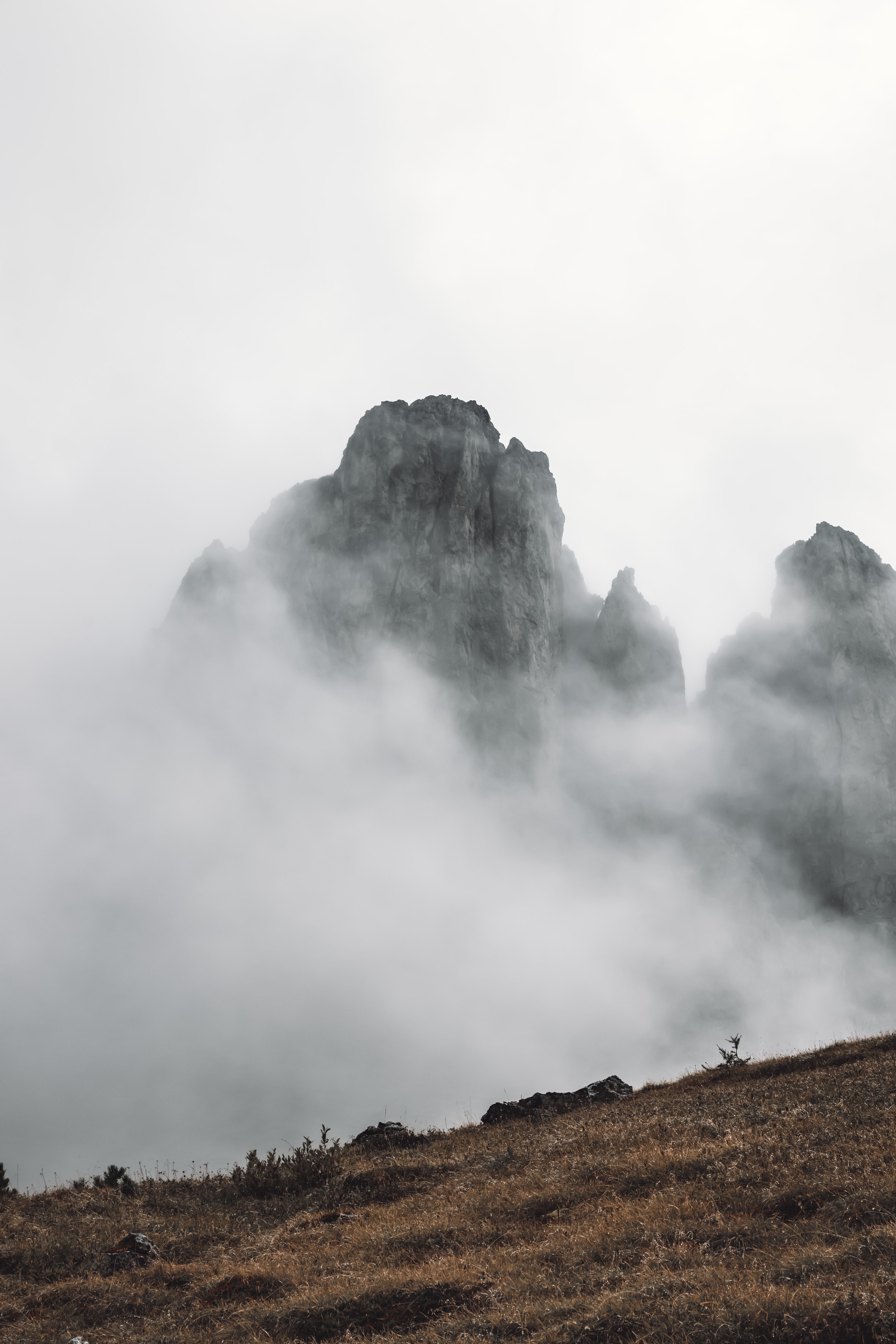 Download mobile wallpaper Slope, Fog, Grass, Rocks, Nature, Mountains for free.