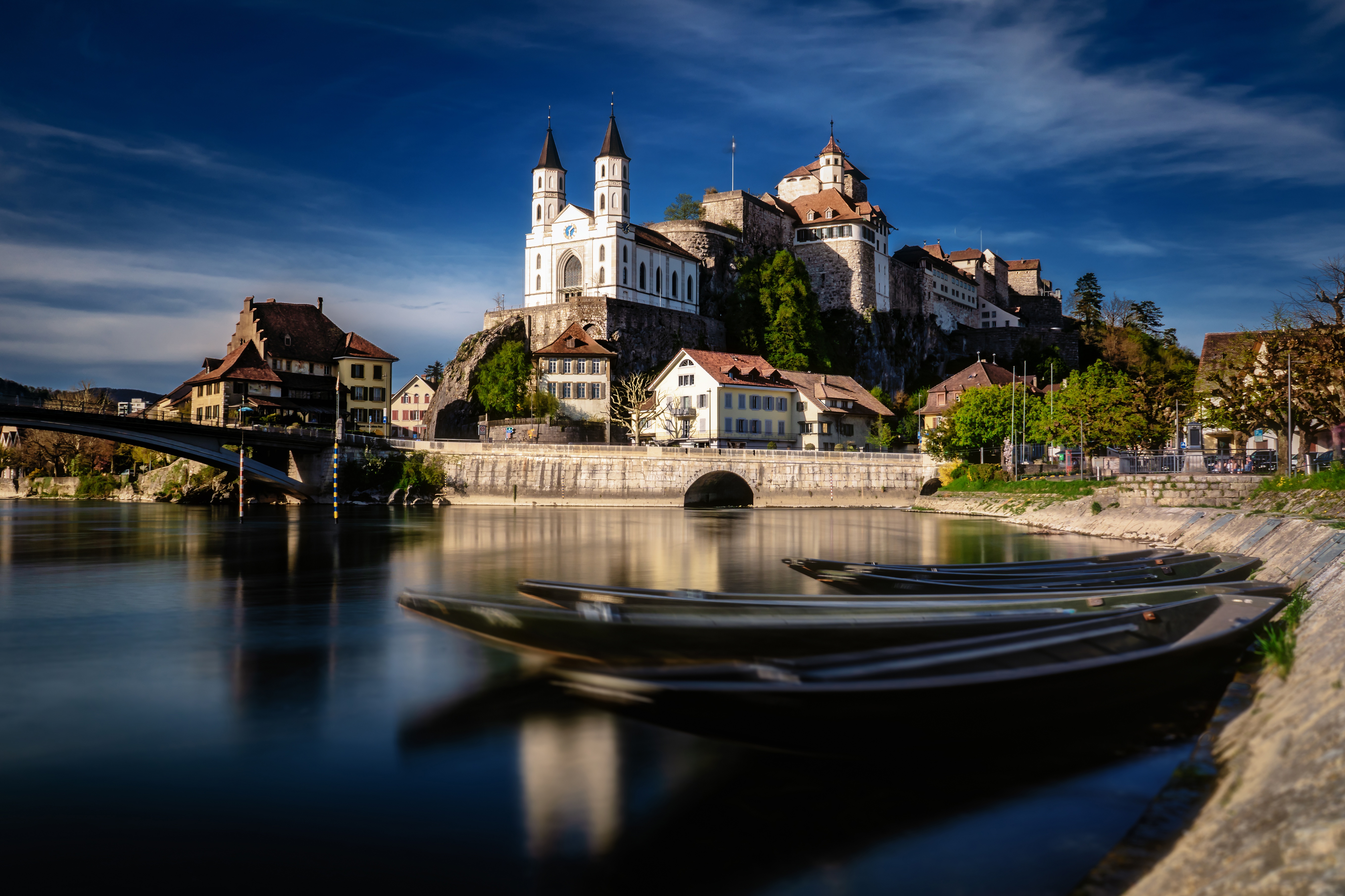 Download mobile wallpaper Castles, Building, Bridge, Boat, Switzerland, Church, River, Man Made, Castle for free.