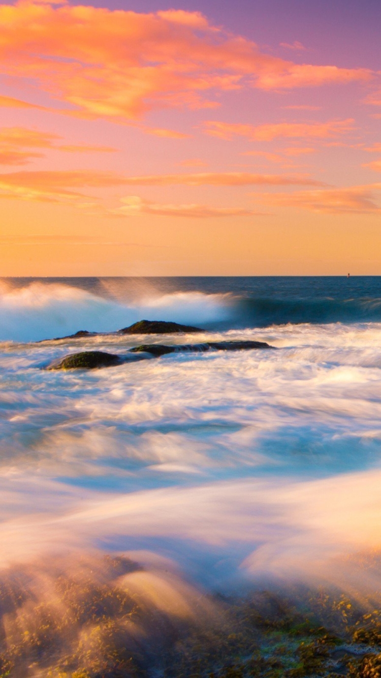 Download mobile wallpaper Sunset, Sky, Horizon, Ocean, Lighthouse, Wave, Man Made for free.