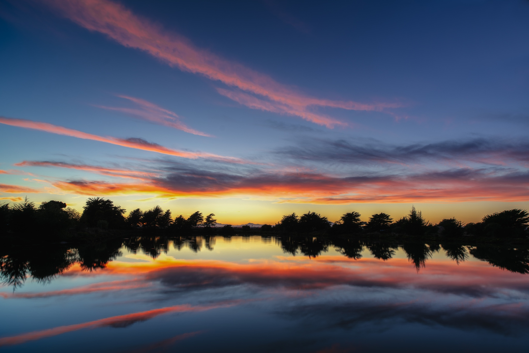 Download mobile wallpaper Landscape, Nature, Water, Sunset, Reflection, Tree, Earth, Cloud for free.