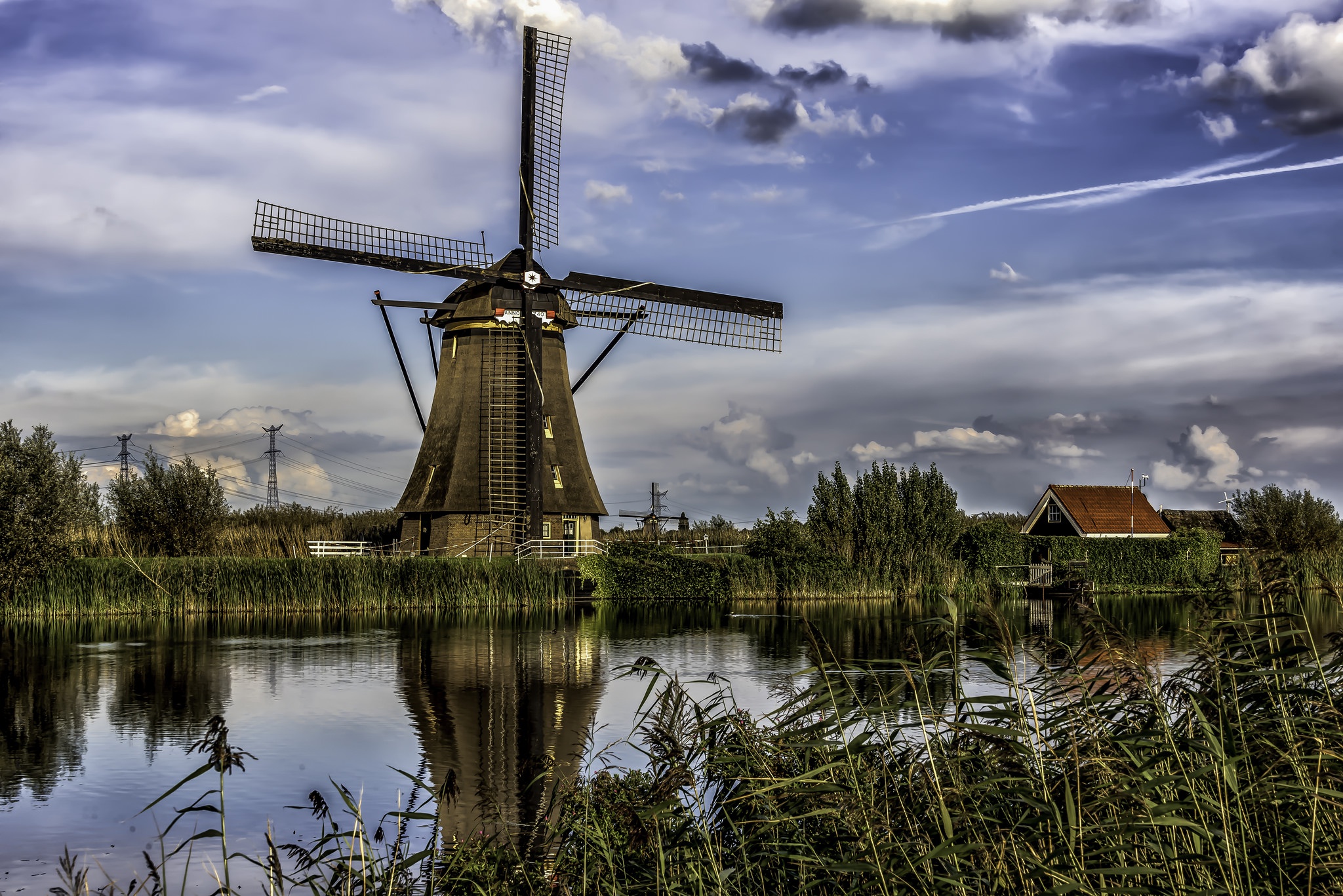 Download mobile wallpaper Sky, Building, Reflection, River, Windmill, Man Made for free.