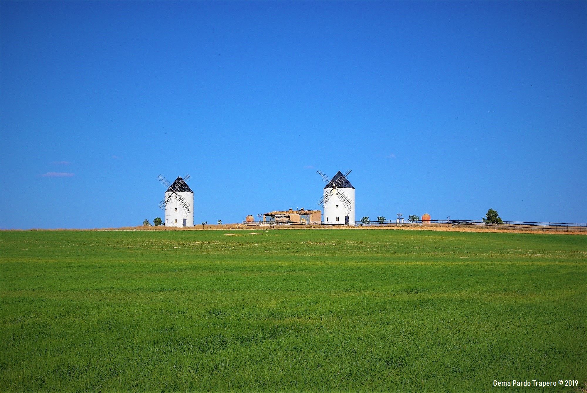 Download mobile wallpaper Grass, Field, Spain, Windmill, Man Made, Castilla La Mancha for free.