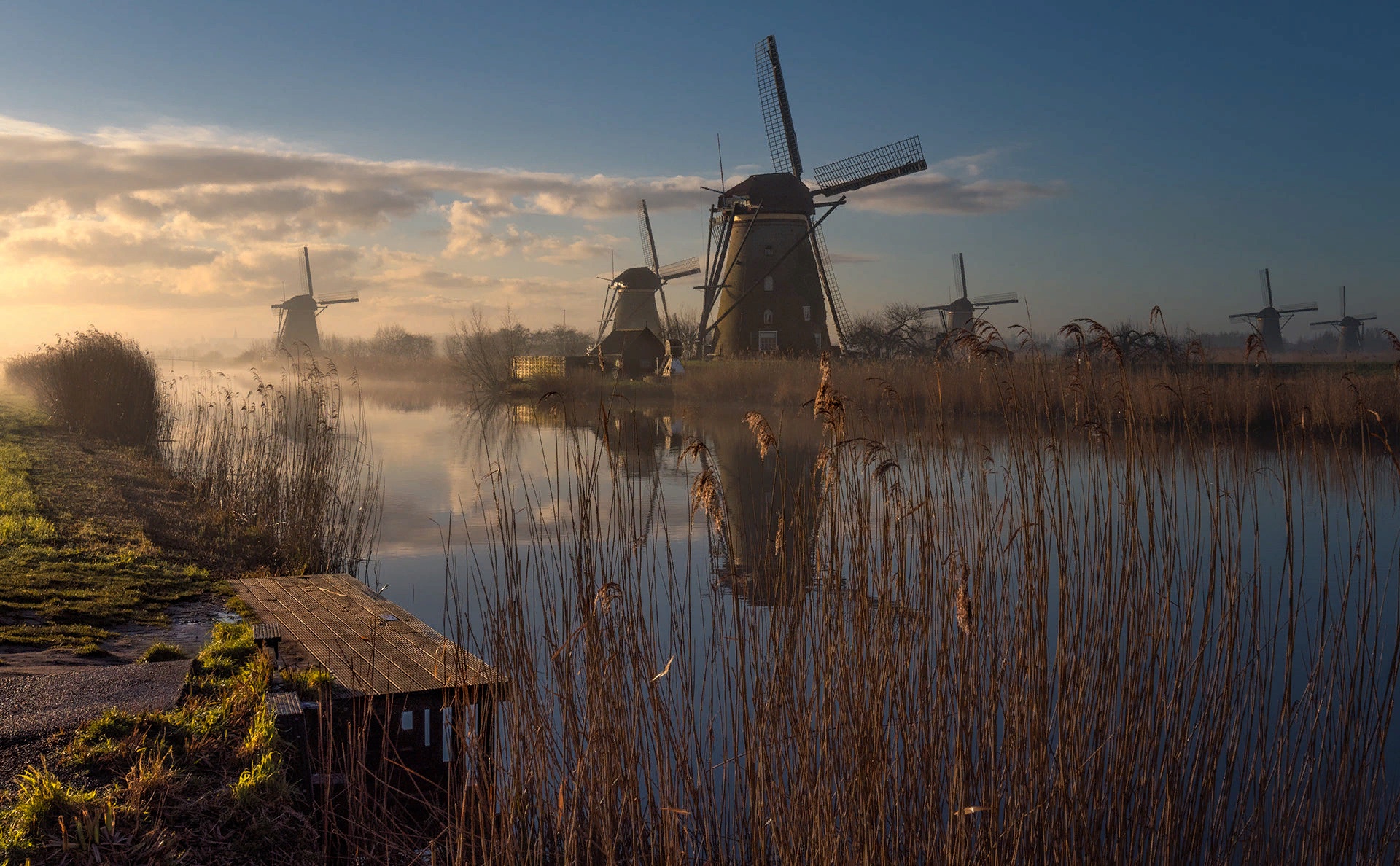 Download mobile wallpaper Reflection, Fog, River, Netherlands, Windmill, Man Made for free.